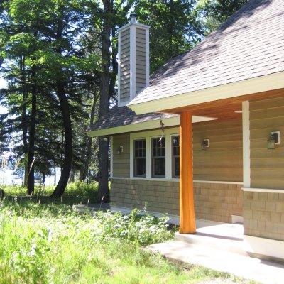 Natural cedar log column at entrance of new cottage Northern Michigan residential architecture