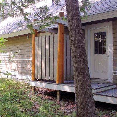 Outdoor shower with cedar log columns  